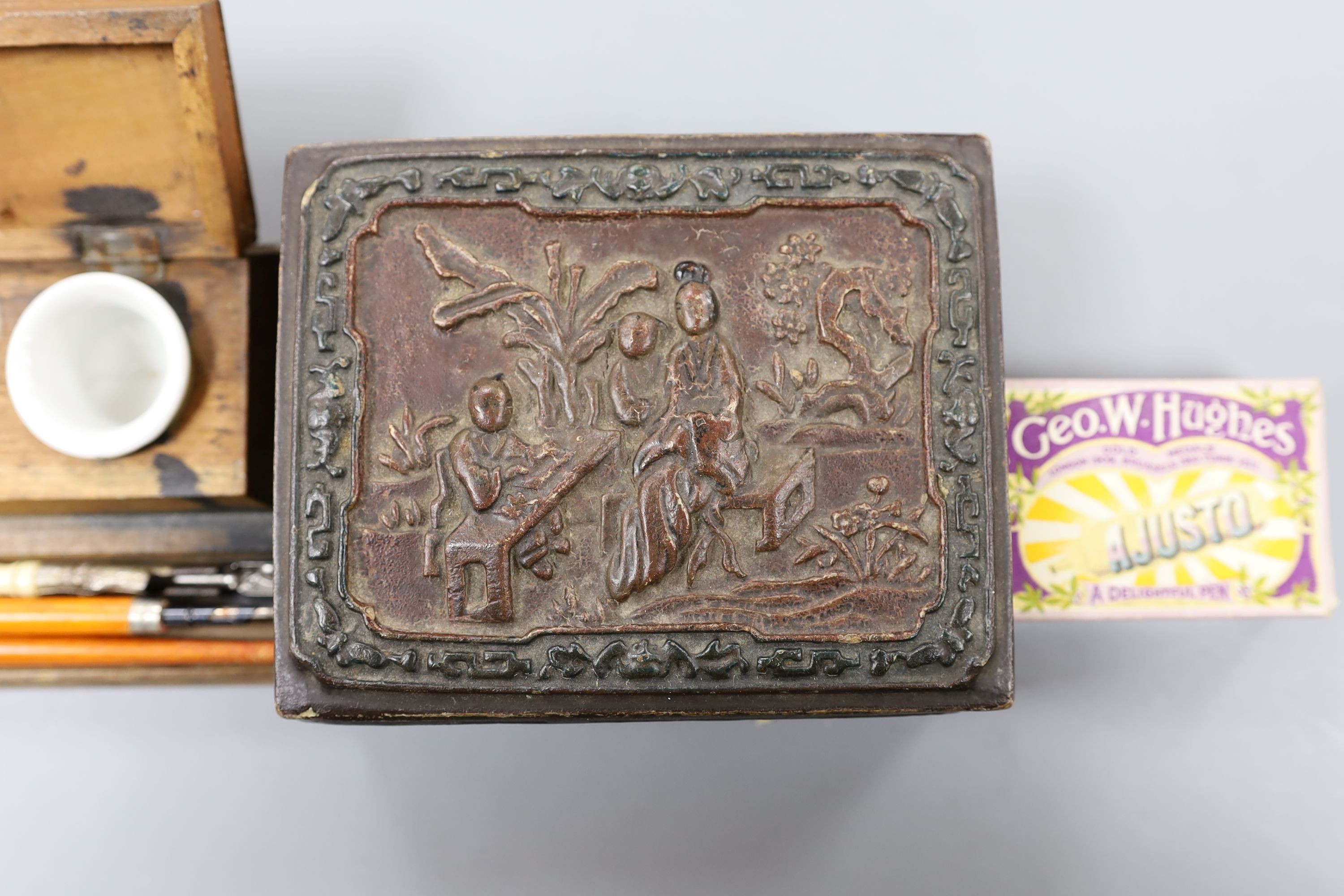 A Chinese rectangular lacquered composition box, an inkstand, three knib-pens and knibs